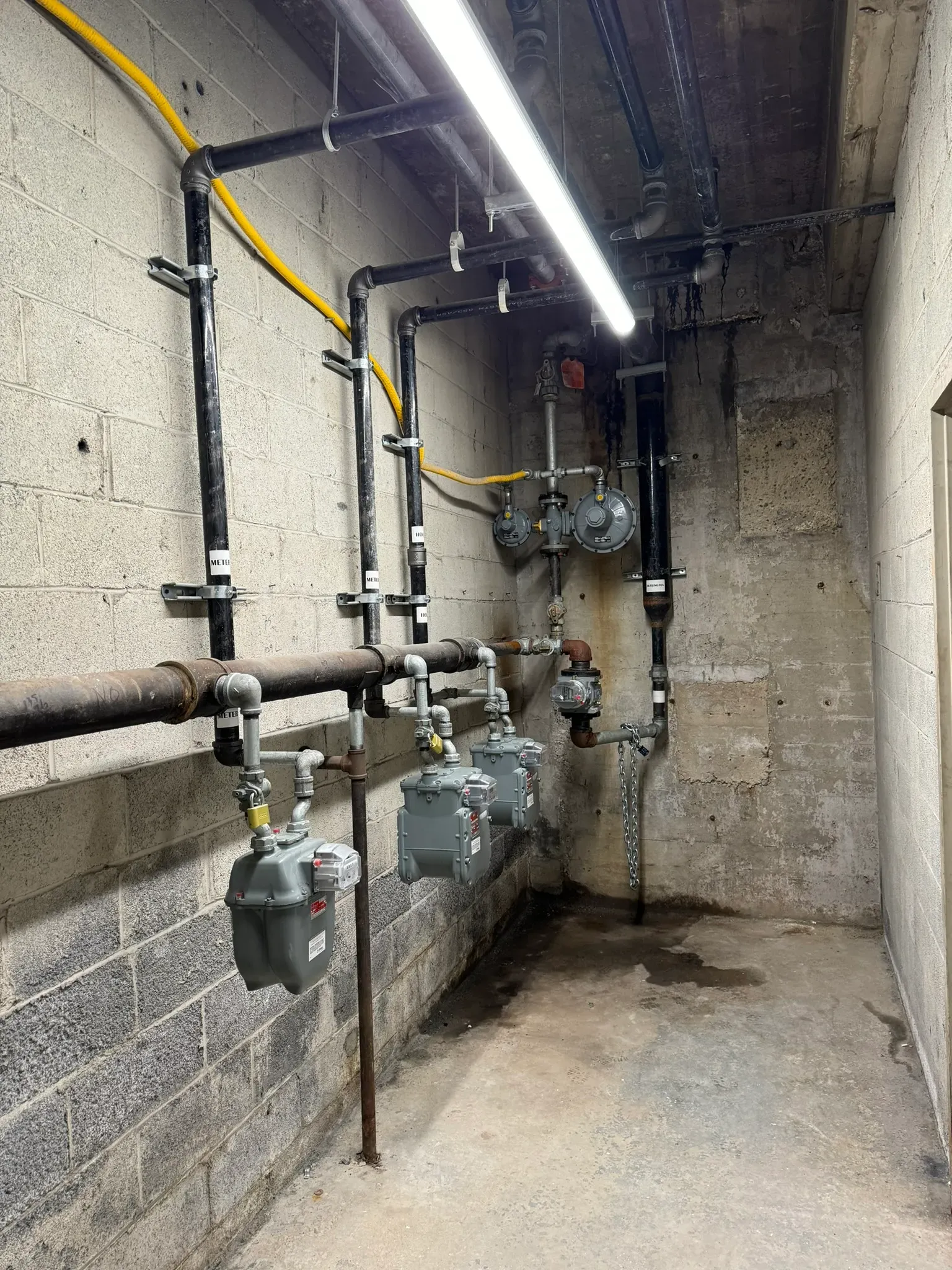 Natural gas meter and distribution room for a commercial or multi-unit building