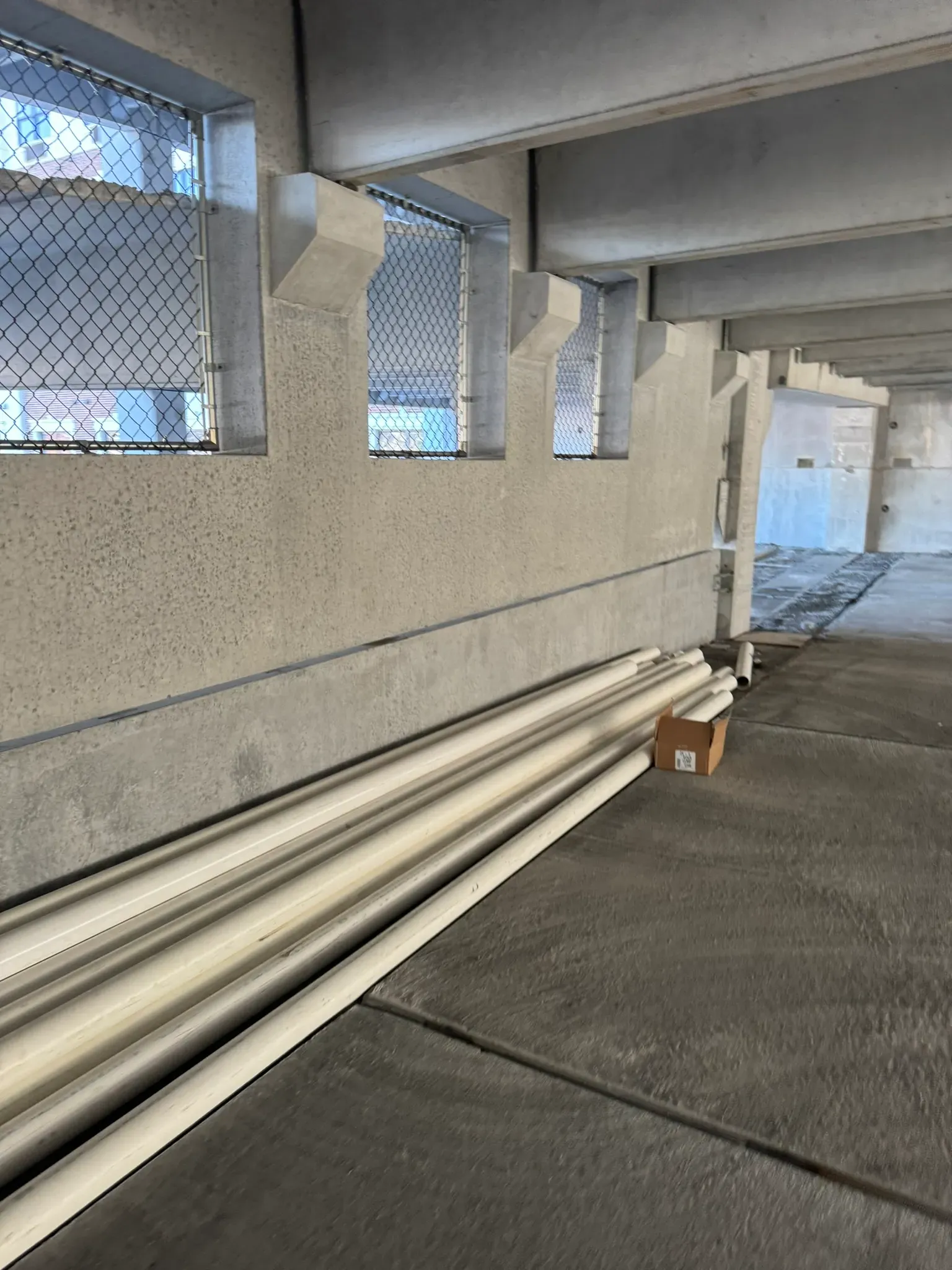 PVC pipe preparation in a parking garage